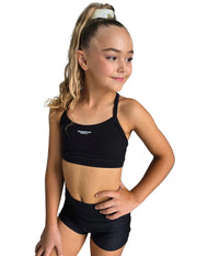 Young girl in black STUDIO CROP top and matching shorts, smiling and posing confidently, perfect for dance or studio sessions.