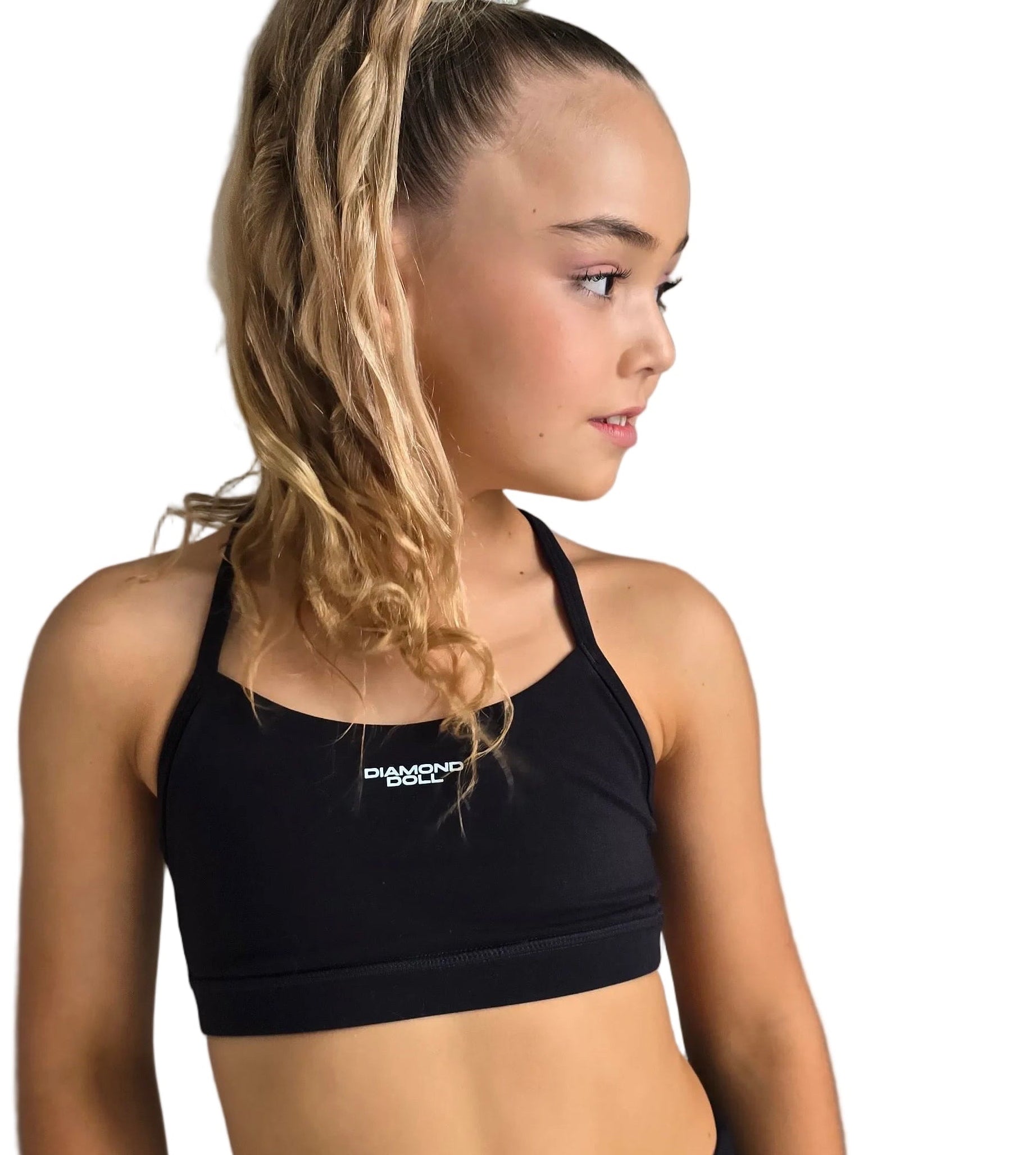 Girl wearing a black sports bra from Diamond Dance, showcasing activewear for kids.