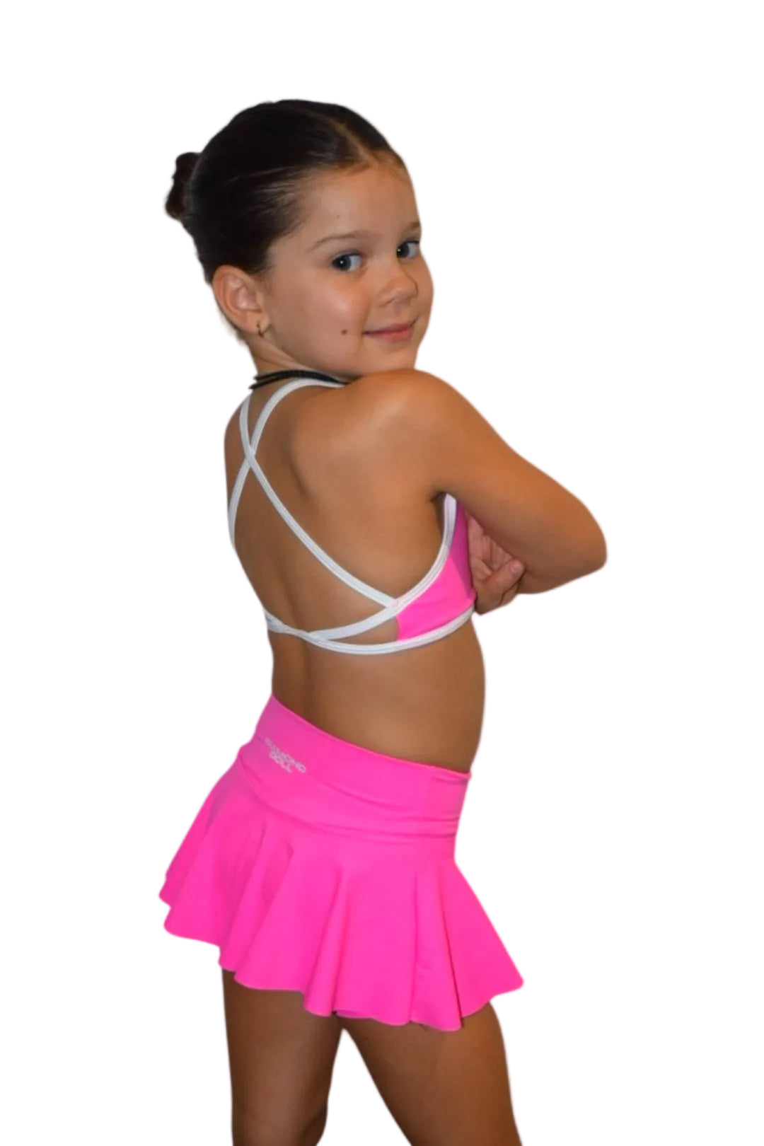 Young girl modeling Malibu Pink - Crop with a vibrant hot pink skirt, showcasing movement and style for athletic activities.