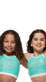 Two girls wearing Teal Sky crop tops with rhinestone detailing, showcasing a fun and stylish look.