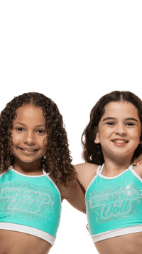 Two girls wearing Teal Sky crop tops with rhinestone detailing, showcasing a fun and stylish look.