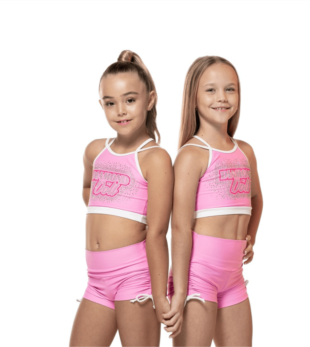 Bubblegum Pink -  Short, featuring two girls in matching pink crop tops and scrunch shorts with white bow ties.