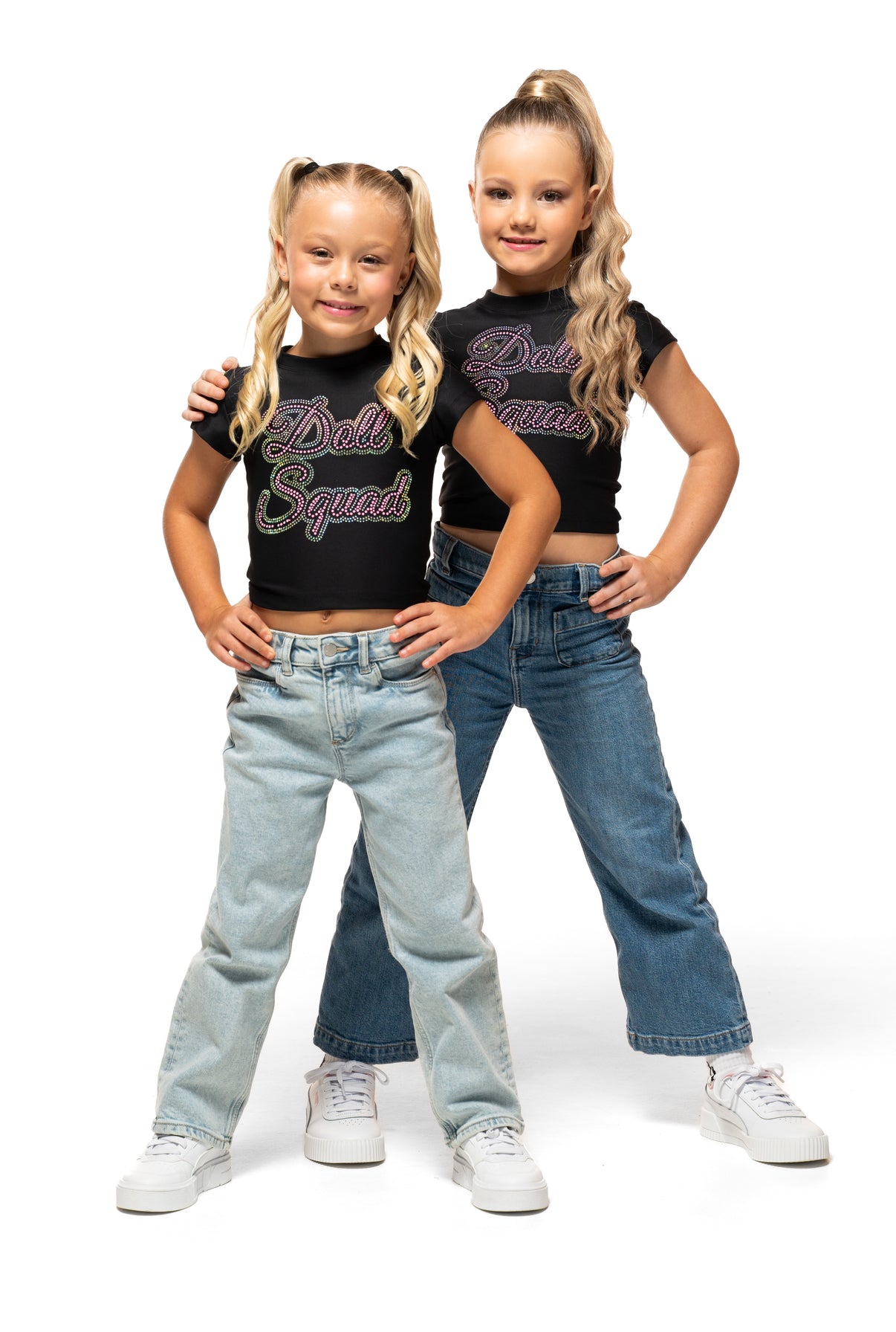 Two kids wearing Doll Squad Baby Tee, styled with jeans, showcasing comfort and trendy fashion.