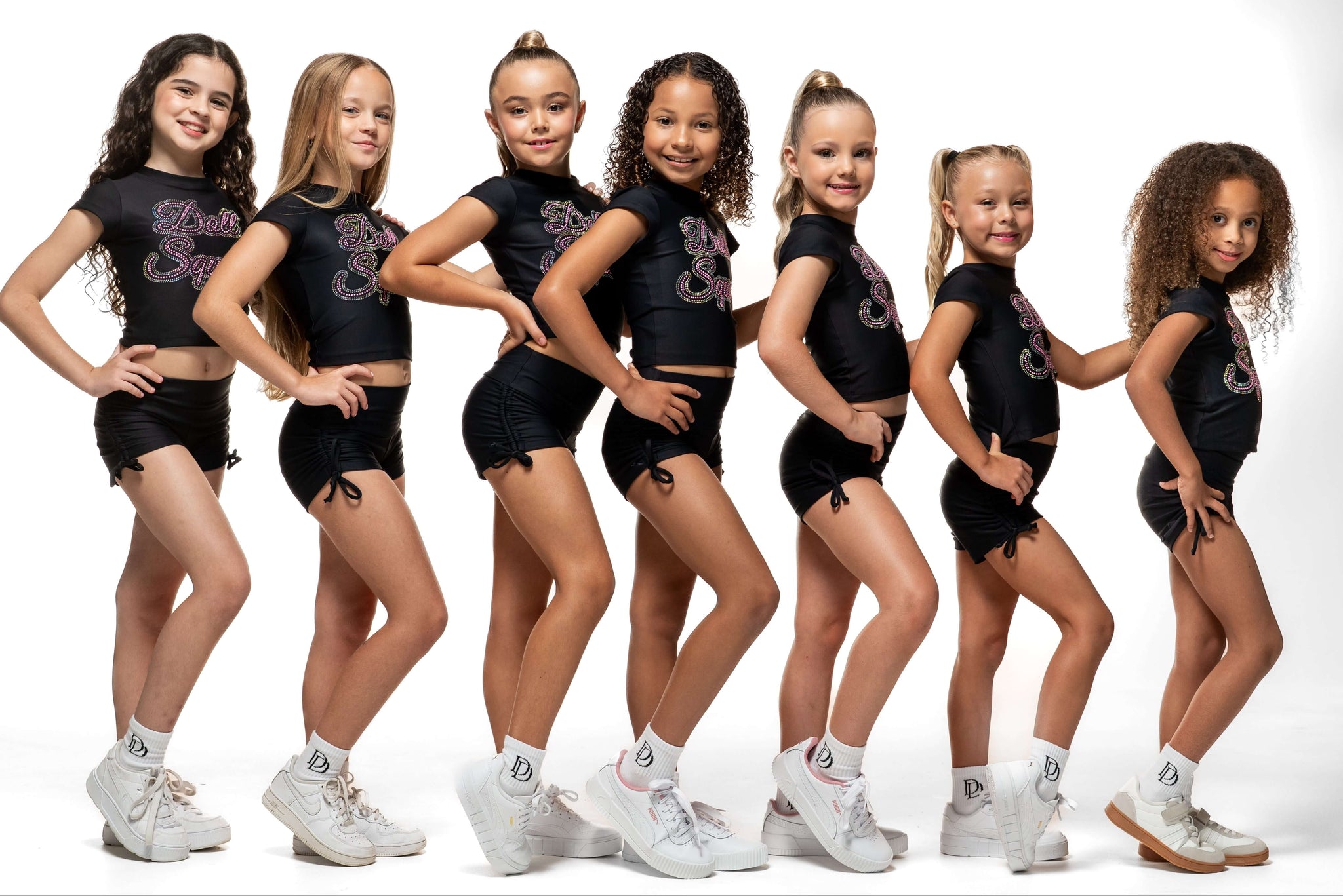 Black Scrunch Side - Short stylishly modeled by young girls, showcasing scrunch sides and cute bow ties.