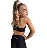 STUDIO ESSENTIALS - SHORTS model showcasing the back view of high-waisted active shorts in a dance-ready outfit.