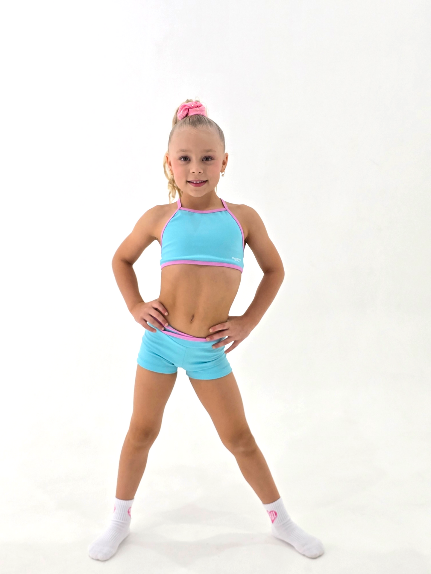 Blue Crush - Crop worn by a young girl, showcasing soft baby blue fabric with pink trim for activewear.