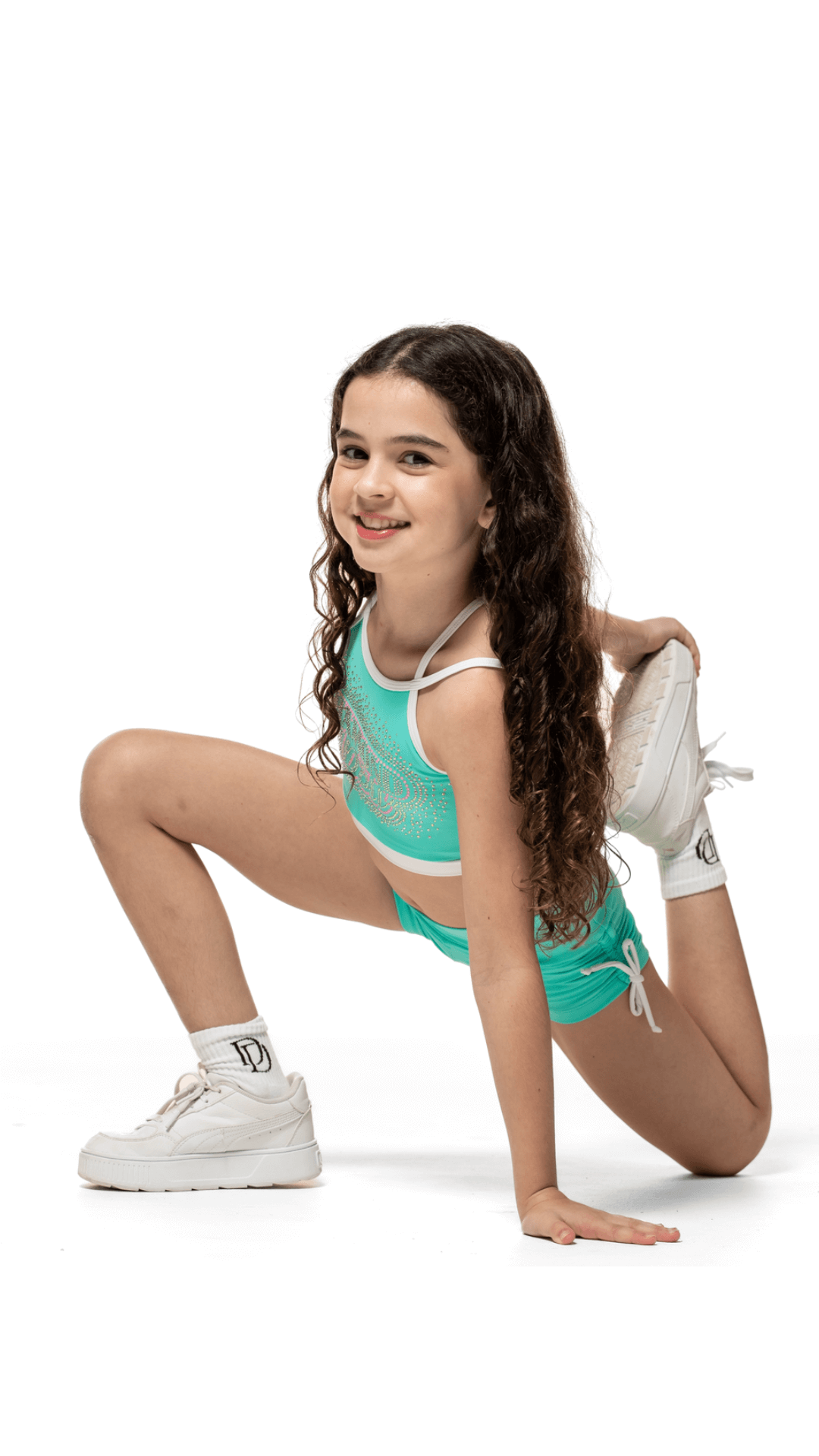Girls model in Teal Sky Bottoms and matching top, showcasing flexibility and comfort in stylish activewear.