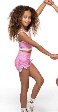 Bubblegum Pink -  Short model showcasing high-waisted scrunch shorts with white bow ties.