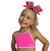 Malibu Pink - Crop featuring a young girl in a vibrant hot-pink crop top with a sparkly hair bow, perfect for dance and cheer.