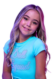 Doll Squad Rhinestone baby Tee | Diamond Doll Couture worn by a smiling girl with long wavy hair.