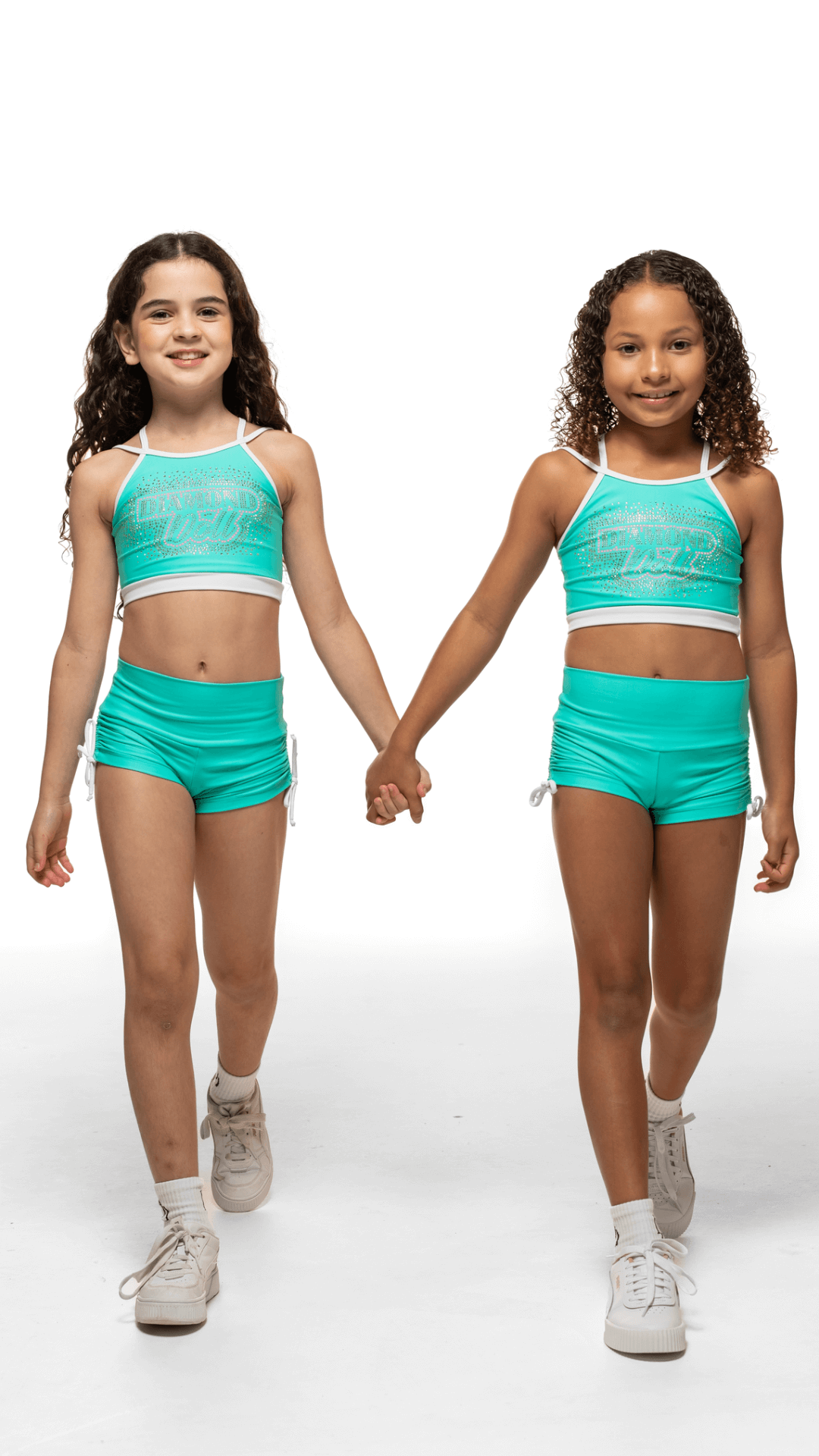 Two girls wearing Teal Sky Bottoms and matching crop tops, showcasing playful fashion and comfort.