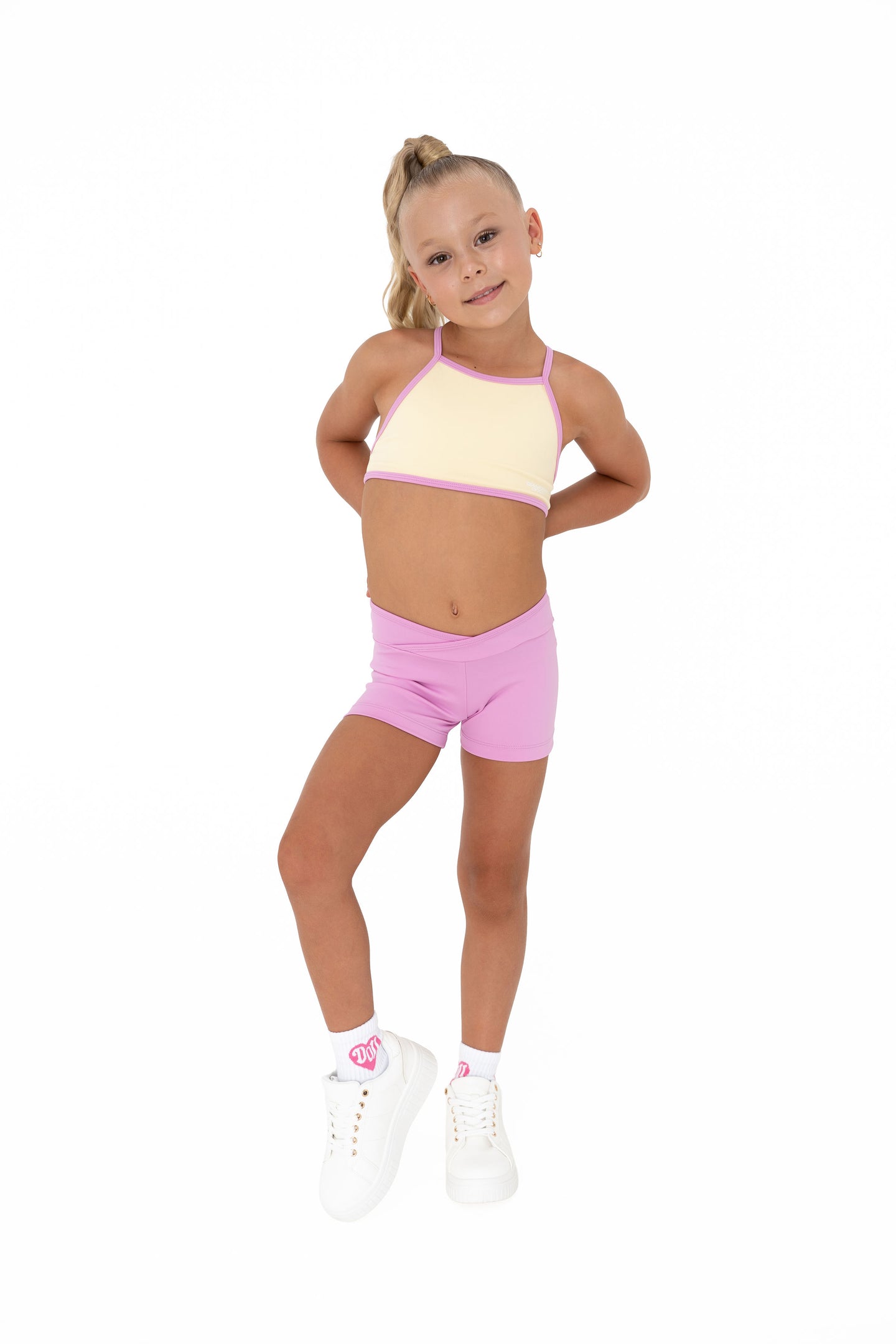 Pink Lemonade – Crop worn by a young girl in a cheerful pastel outfit, perfect for summer training.