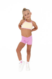 Pink Lemonade – Crop worn by a young girl in a cheerful pastel outfit, perfect for summer training.