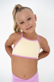 Pink Lemonade – Crop model wearing a pastel yellow and pink activewear top, perfect for summer training.