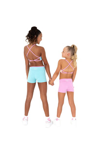 Two girls wearing Blue Crush - V Waist Shorts and matching tops, showcasing a pastel blue and pink activewear look.