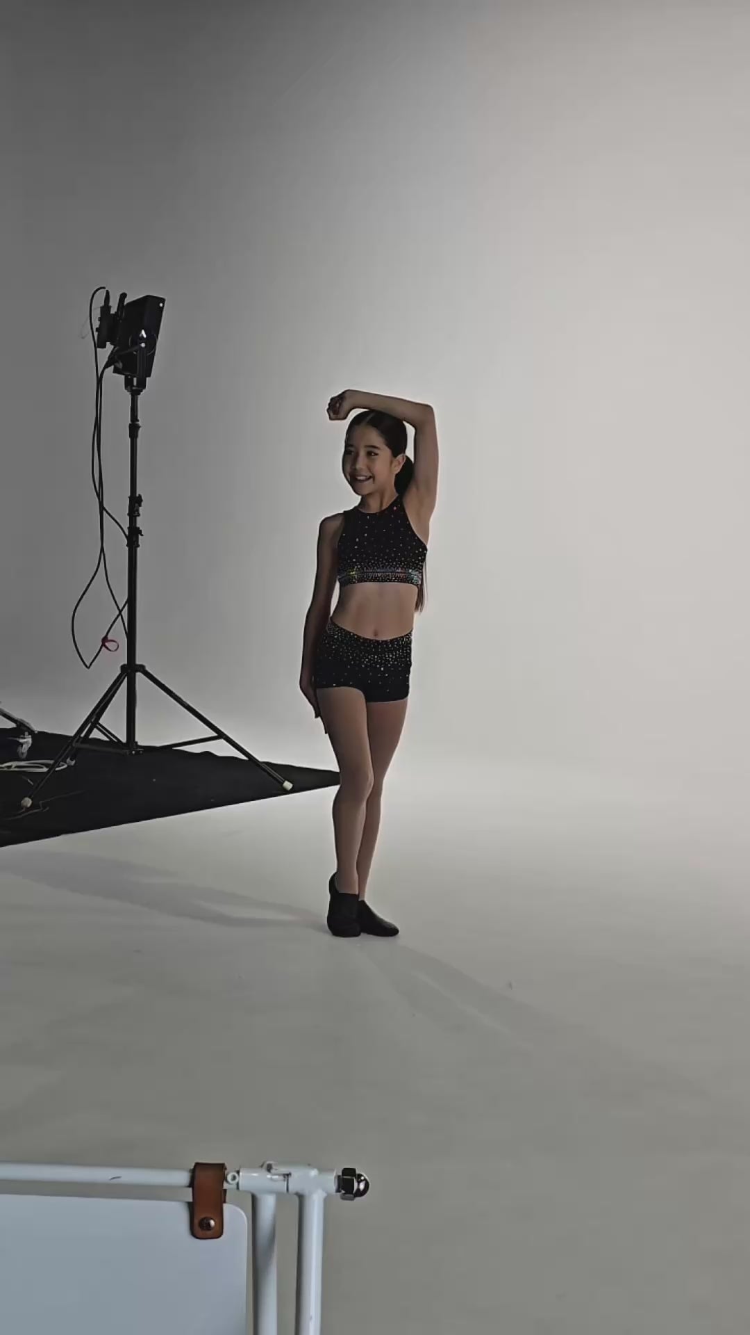 Midnight Dream Crop | Diamond Doll Couture model posing in studio, showcasing the black sparkling crop outfit.